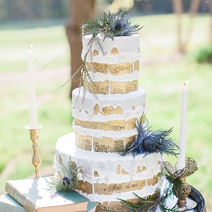 Gold-brushed naked cake accented with blue thistles