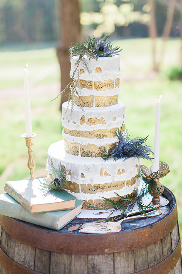 Gold-brushed naked cake accented with blue thistles