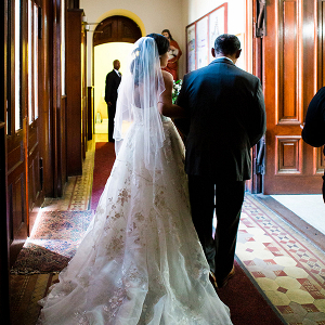 A bride and her father prepare to walk down the aisle
