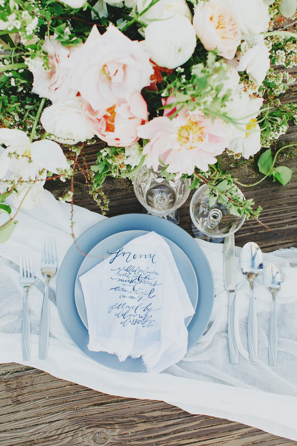 An oceanic place setting with a calligraphed acrylic menu