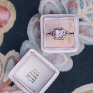 Pink stone engagement ring in a velvet ring box