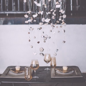 Rock-inspired tablescape with an earthy chandelier made out of stones and tea lights