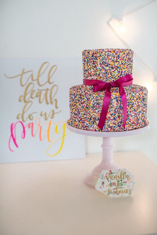 Colorful wedding cake covered in sprinkles