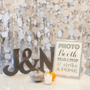 Confetti-inspired photo booth backdrop for an urban autumn wedding