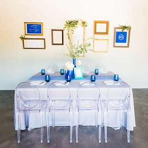 Minimalist tablescape with blue details and ghost chairs