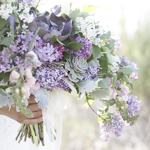 An earthy spring bouquet with lilacs and succulents