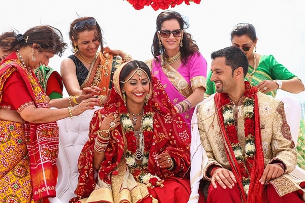 The Bride and the Groom are Sitting Under the Mandap with their Guests after the Wedding