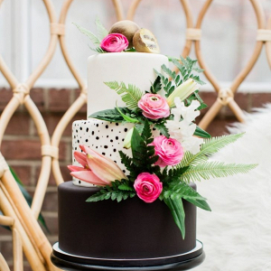 Tropical black and white wedding cake with pink florals