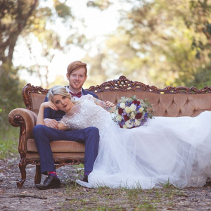 Bride and groom on vintage couch