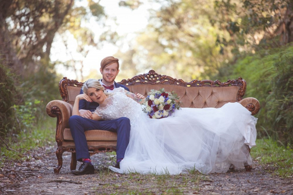 Bride and groom on vintage couch