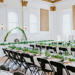 Wedding reception with long tables and greenery runners