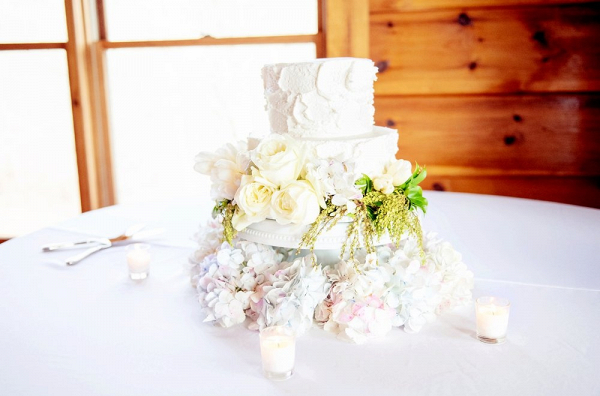 Small buttercream wedding cake with fresh flowers