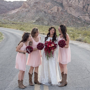 Bridesmaids in pink dresses and cowboy boots