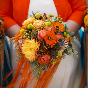 Colorful orange wedding bouquet shot by Amy Ann Photography