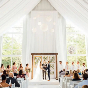Open white barn wedding ceremony