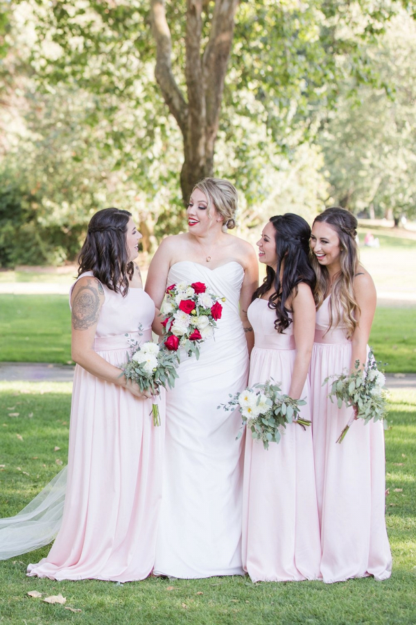 Bride with red lip with blush bridesmaids