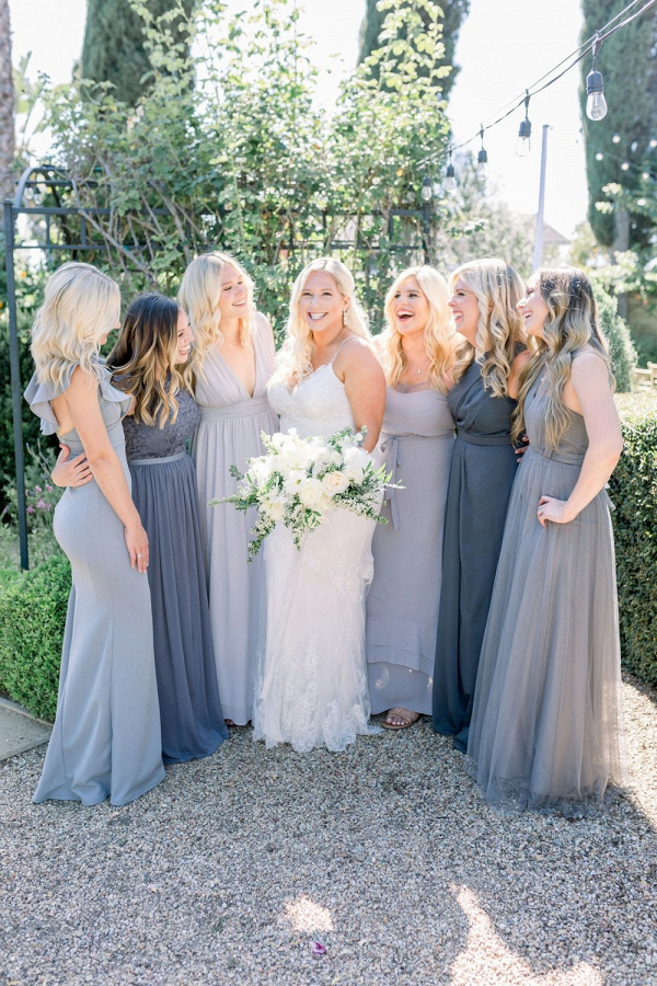Bridesmaids in mismatched gray dresses