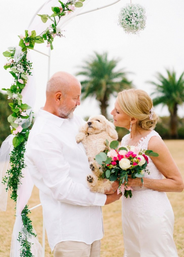 Beach wedding ceremony with dog