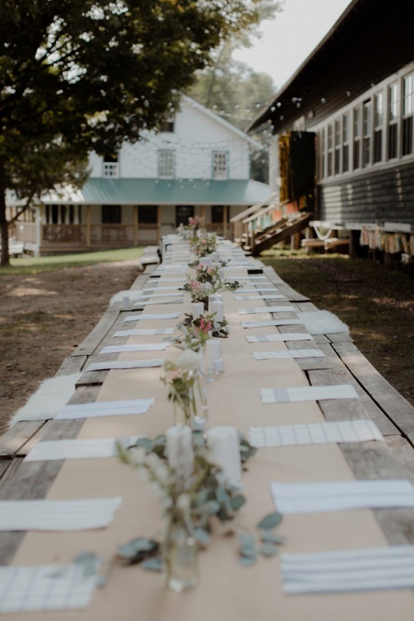 Outdoor wedding reception with long tables and DIY centerpieces