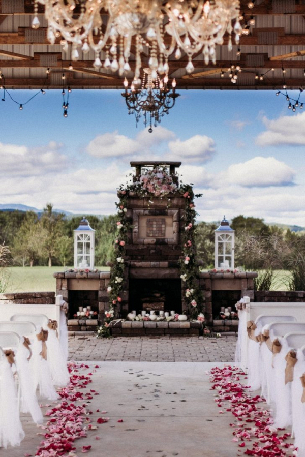 Rustic wedding ceremony with fireplace altar
