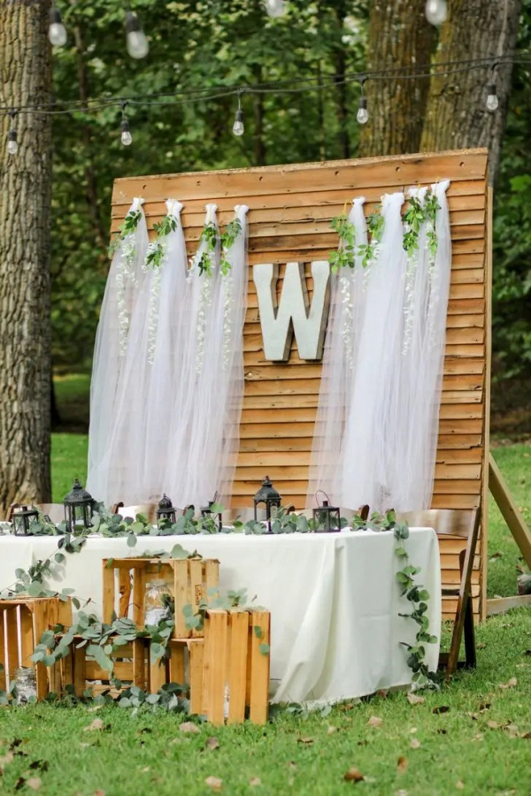 Rustic sweetheart table with wooden backdrop