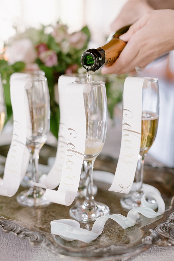 Calligraphy paper curls for champagne flutes