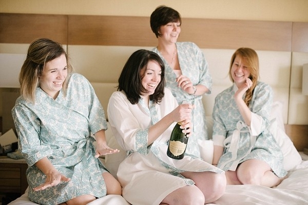 Bridesmaids getting ready with champagne