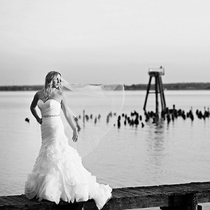 Coastal bridal session bride standing on the dock