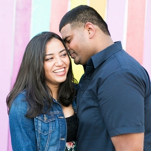 Adorable couple in front of colorful wall