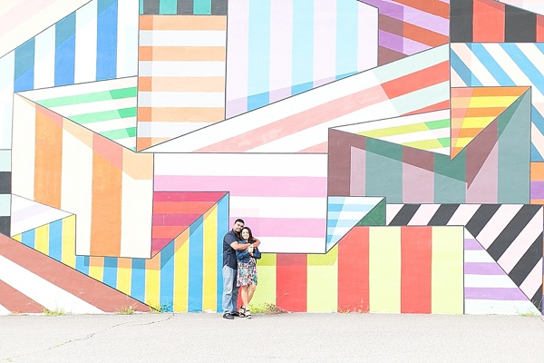 Couple in front of colorful wall mural