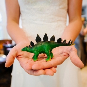 Bride holding dinosaur