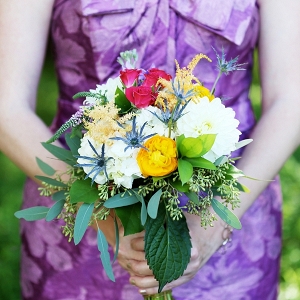 Colorful bridesmaid bouquet with purple patterned dress