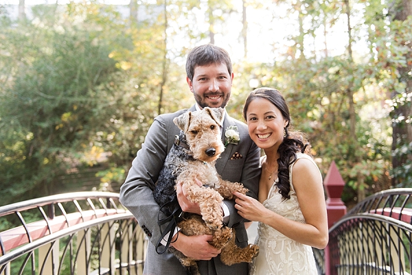 Bride and groom holding their dog