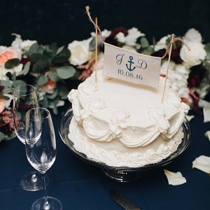 Cute wedding cake with nautical cake topper