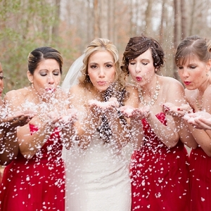 Red bridesmaid dresses and snow confetti
