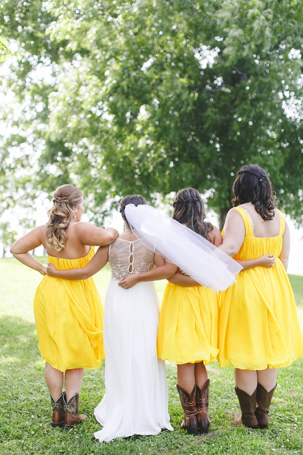 Bridesmaids in yellow dresses and cowboy boots