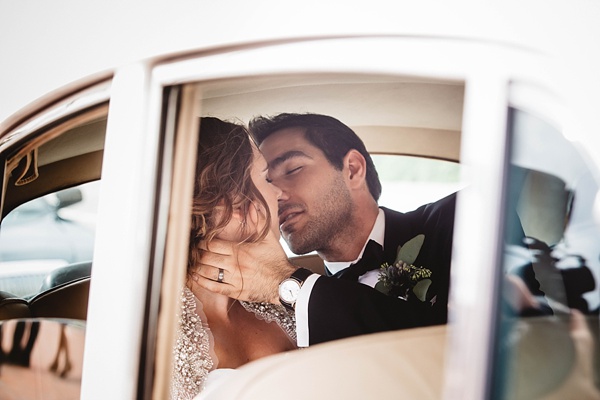 Bride and groom in classic car