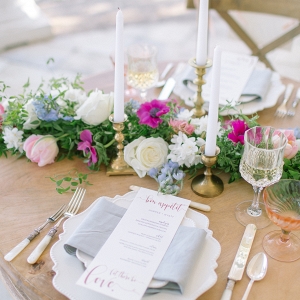 Taper candle and floral runner reception tables