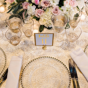 Gold Beaded Chargers on Textured White Linens 